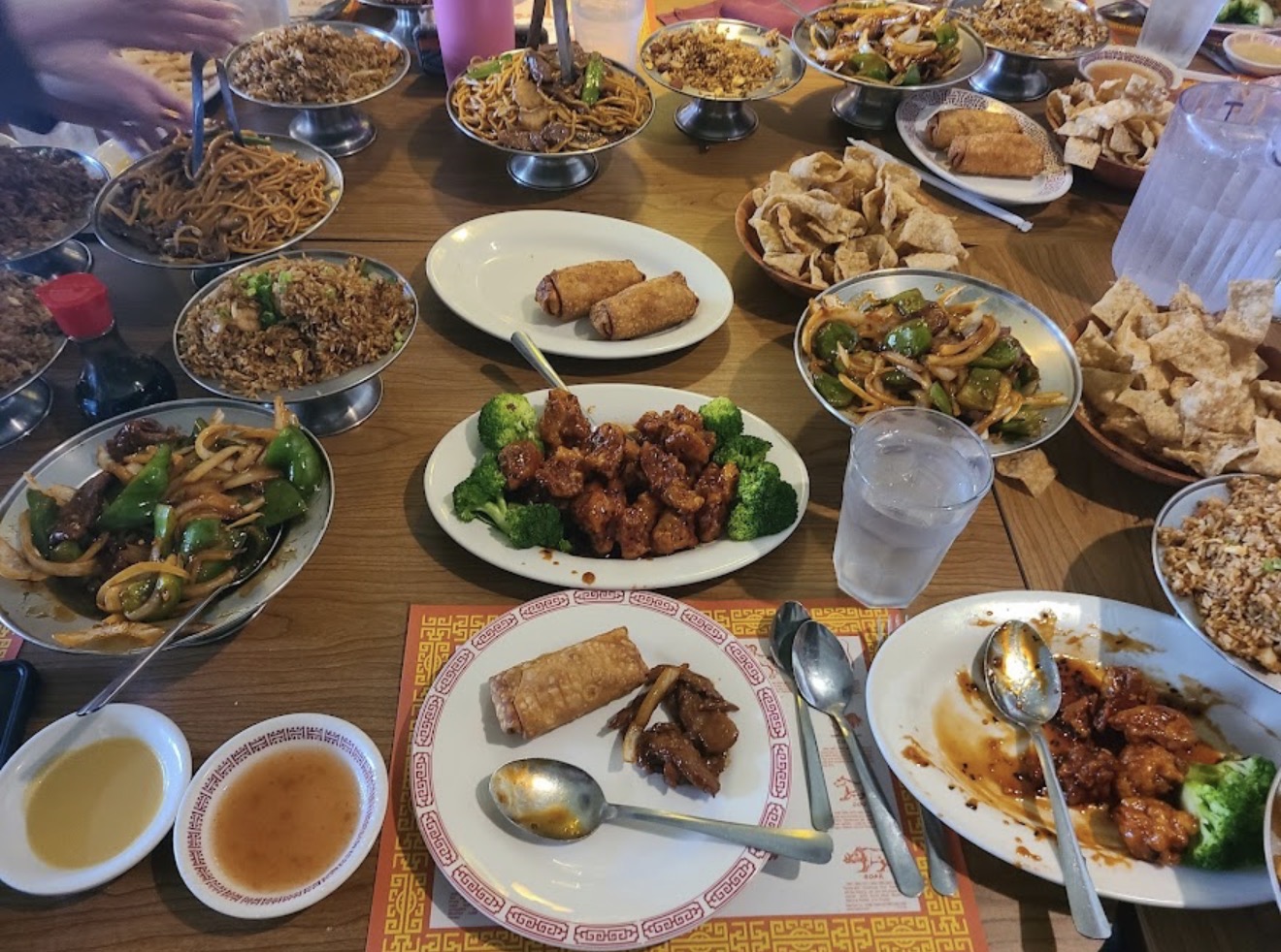 A spread of Hong Luck classics: General Tso's, lo mein, fried rice, and egg rolls